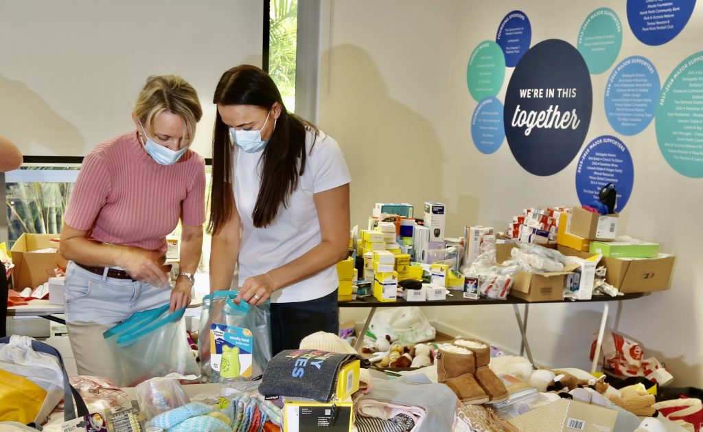 two women looking at donations table