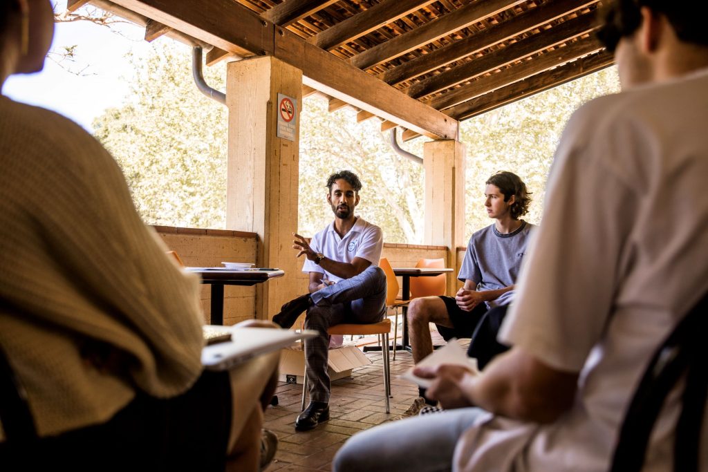 small group sitting in a circle and talking