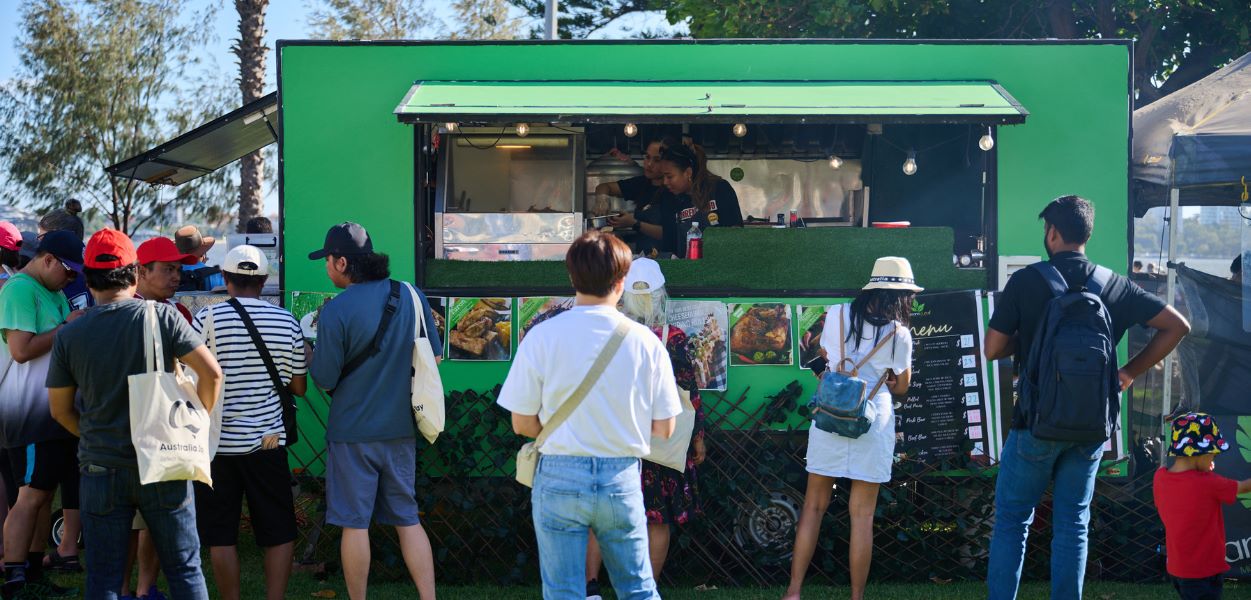 people standing in front of food truck