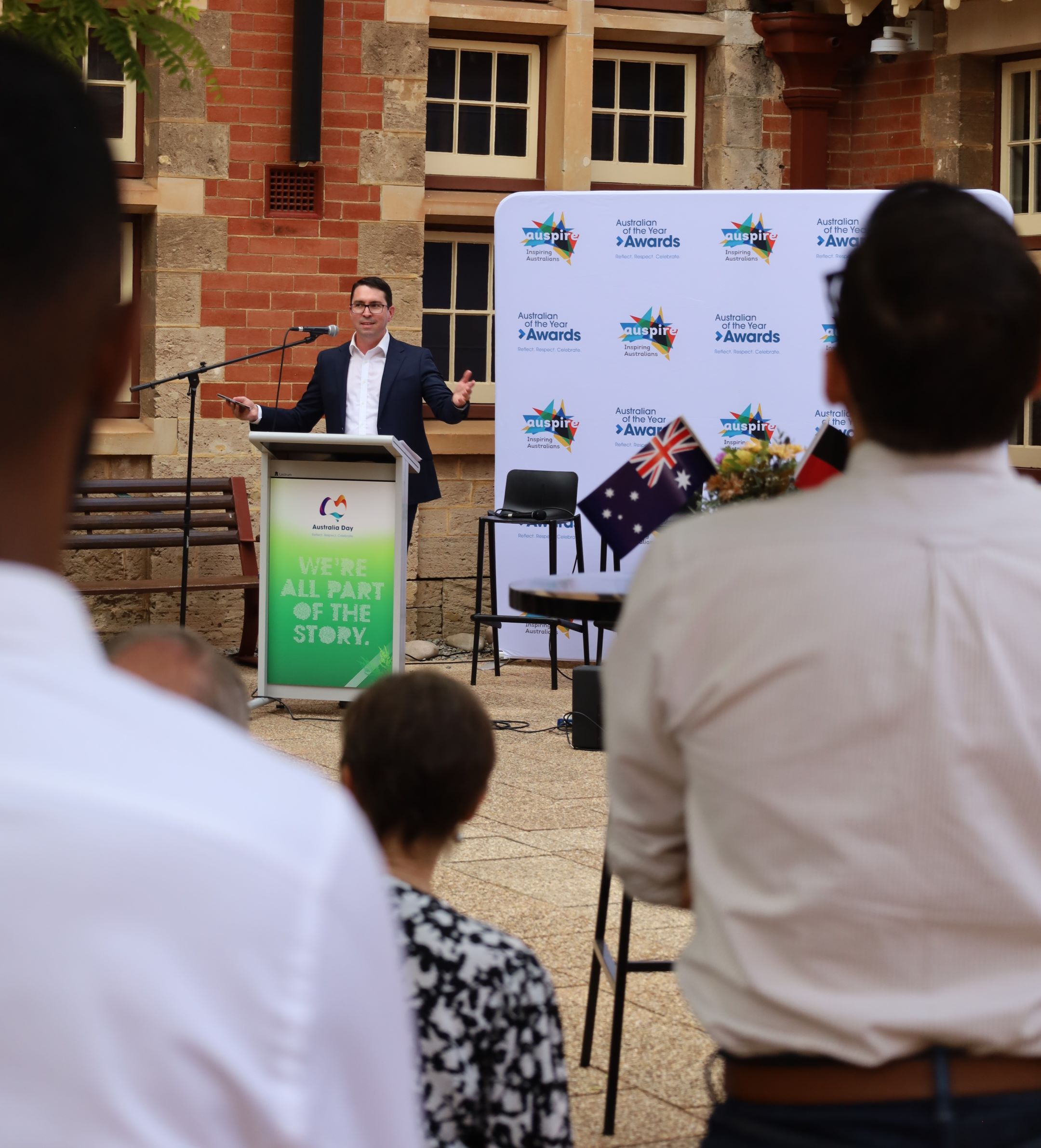 man speaking at lectern at event