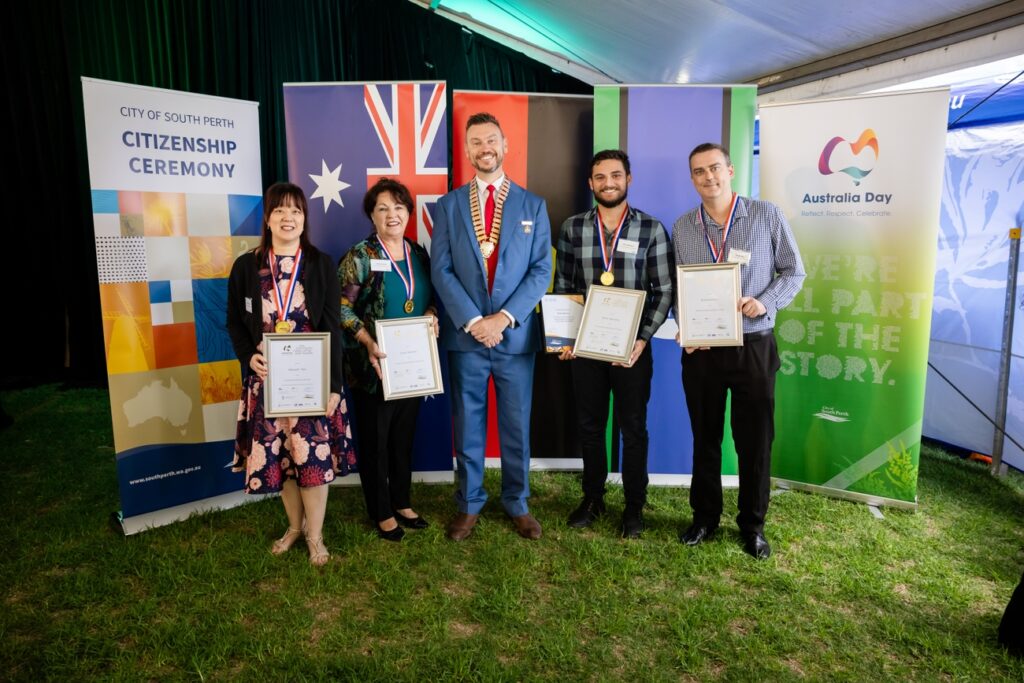 group of people smiling to camera and holding certificates