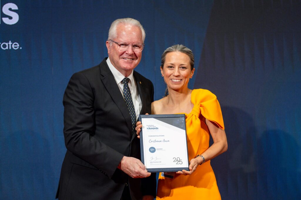 woman holding certificate beside WA Governor