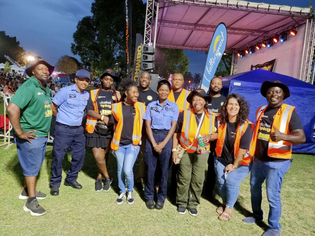 group of people wearing hi vis at festival and smiling to camera