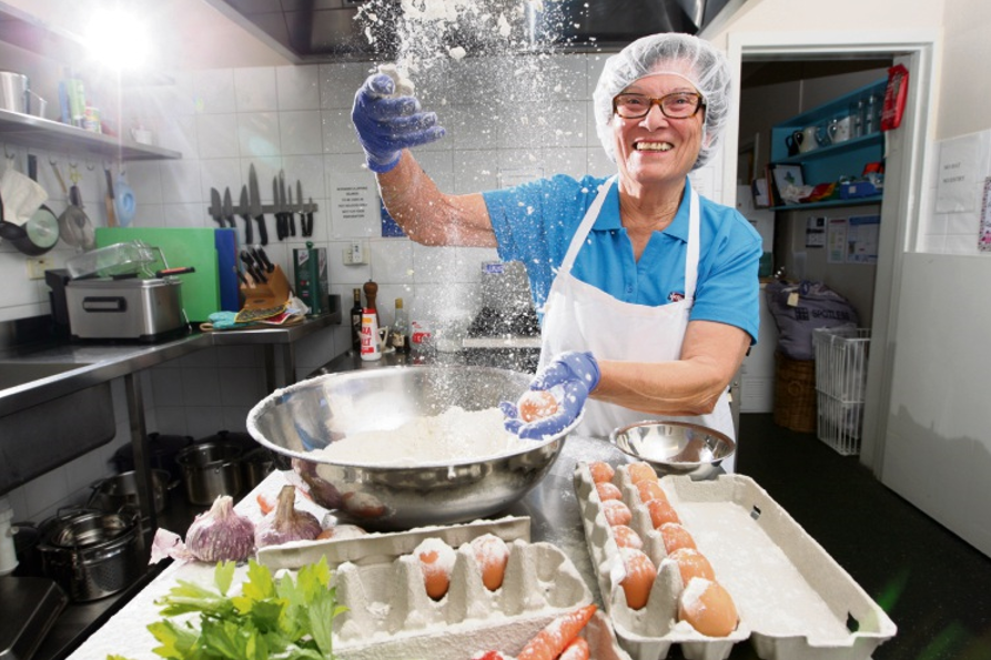 Lucia Scata smiling in kitchen with bowl of flour and eggs