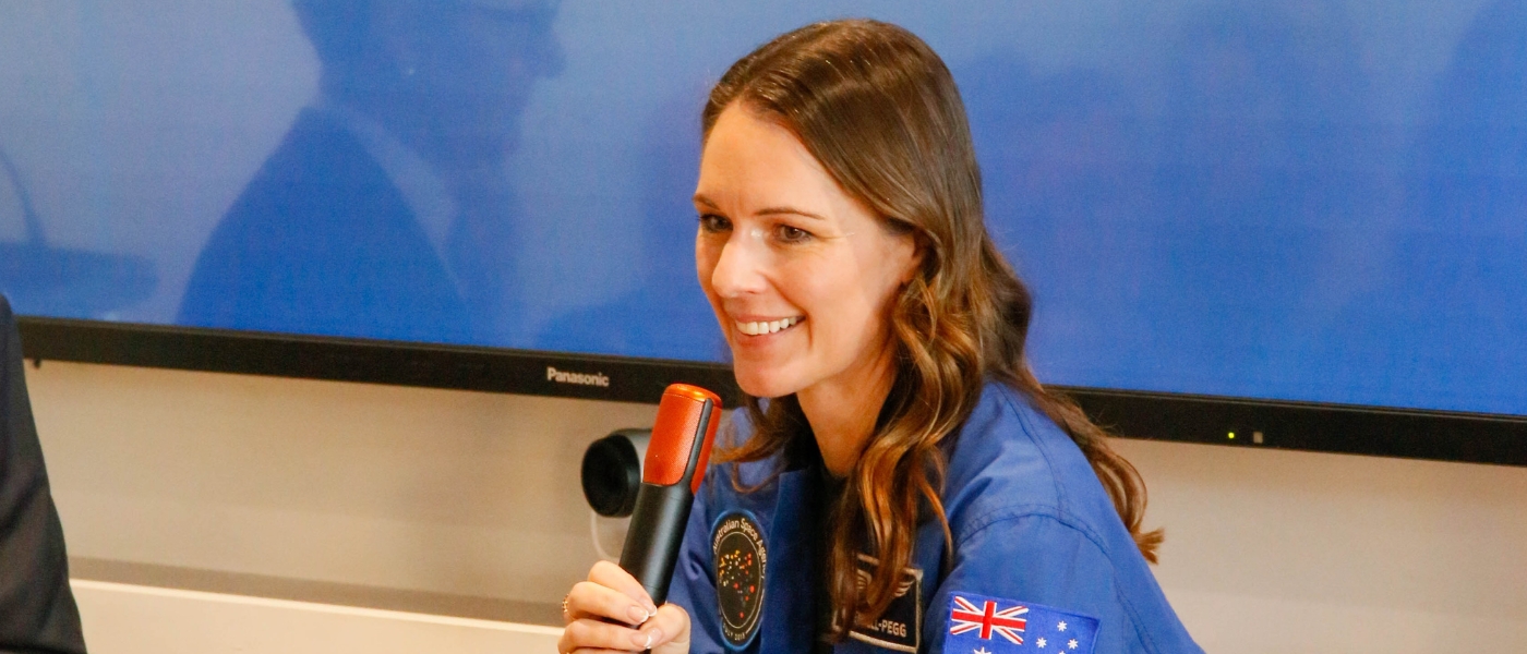 katherine bennell-pegg smiling into microphone