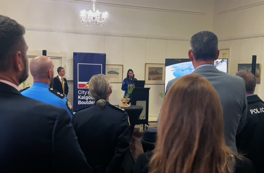 people watching katherine bennell-pegg speaking at lectern