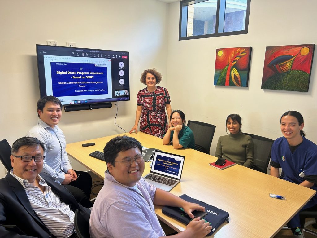 Daniela Vecchio and her team sitting around a table