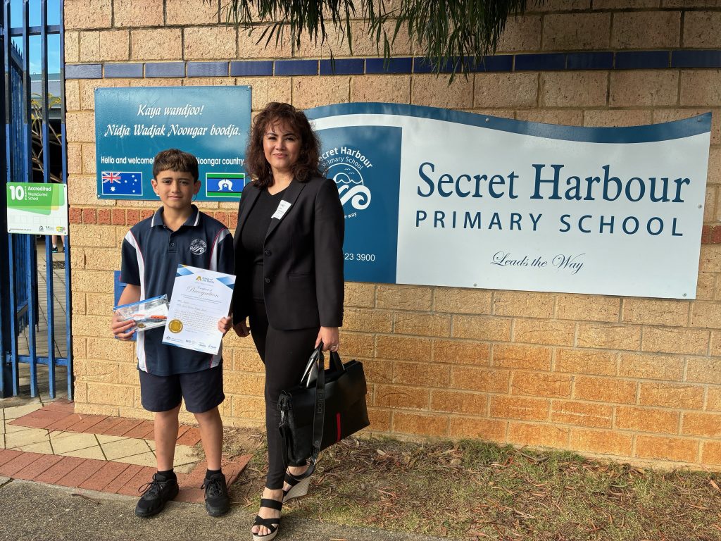 Patchara standing next to Aussie of the Month recipient outside Secret Harbour Primary School